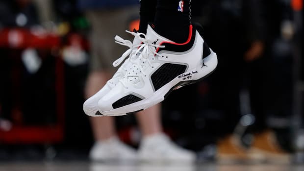 View of Bam Adebayo's white, black, and red Air Jordan shoes.